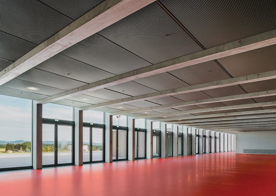 The sizeable entrance lobby eschews Chipperfield’s usual materiality for a corporate red polyurethane floor.