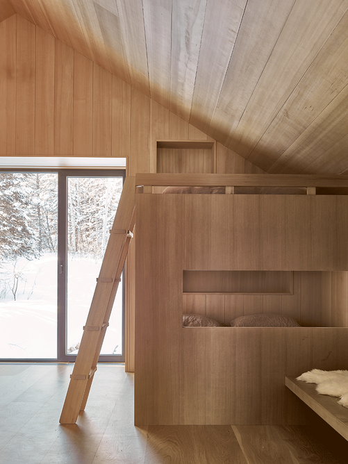 The firm’s second project in Jackson, Snake River Cabin, for a French business family. A bunk room is completely lined in hemlock timber which is common to the region.