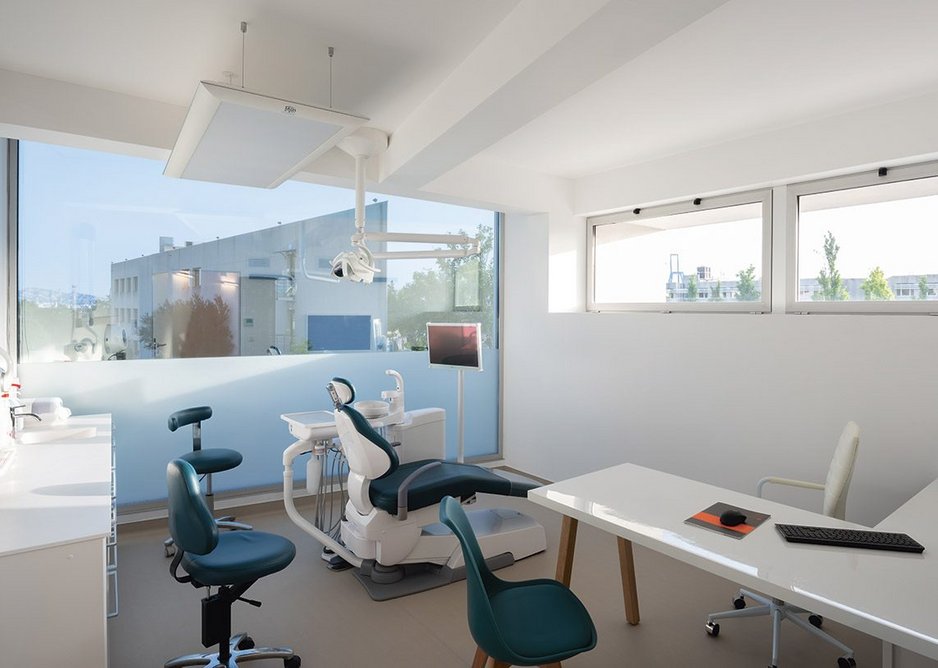 The first floor treatment room with its huge picture window. Here walls are white and more stereotypically dental studio.