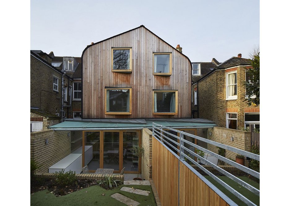 The back of the houses switches, unexpectedly, to timber. Bay windows pushing out from it.