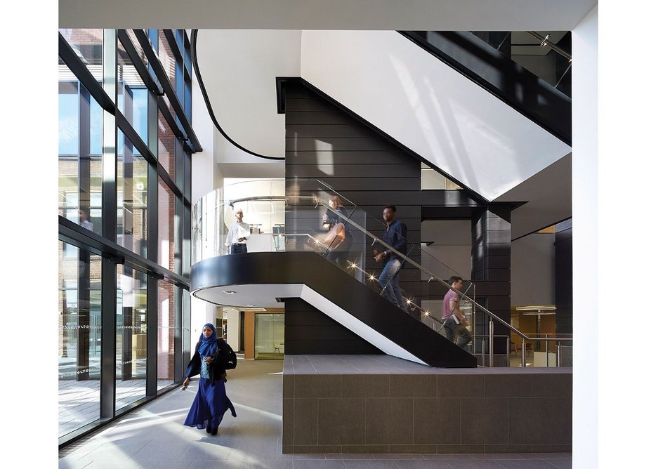 In what was previously outdoor space, the library acquires a new stair clad in dark zinc.