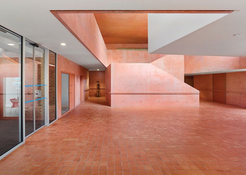 The pink tinted, sculptural concrete atrium. The terracotta floor tiles continue onto the river terrace to the right.