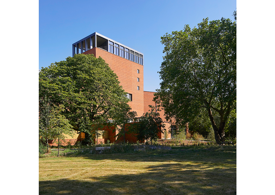 The arms of the library embrace and shelter a new garden by Dan Pearson complete with lake. Credit: Hufton + Crow