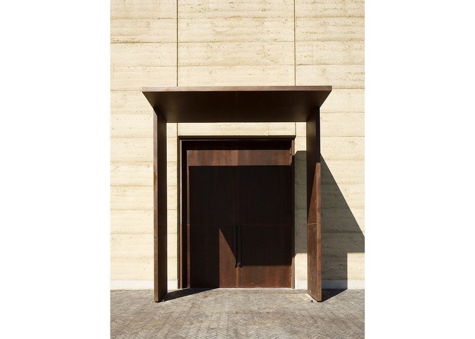 Oversized CorTen doors mark the points of entry and exit.