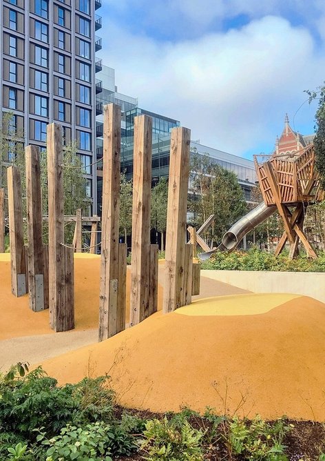 Balance beams next to the main playground structure and slide.