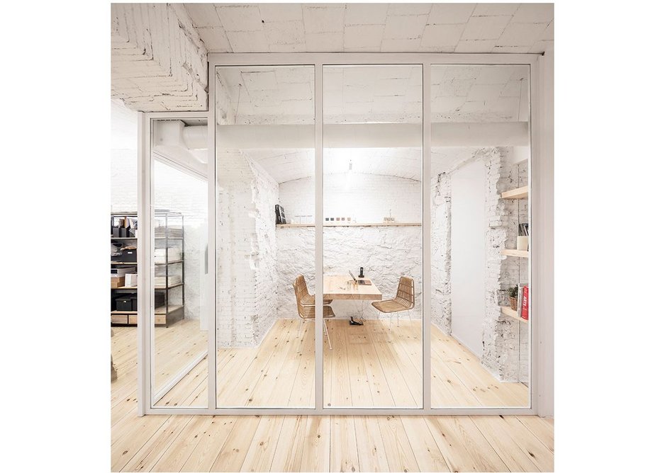 The pine meeting room table projects from the wall- another minimalist intervention.