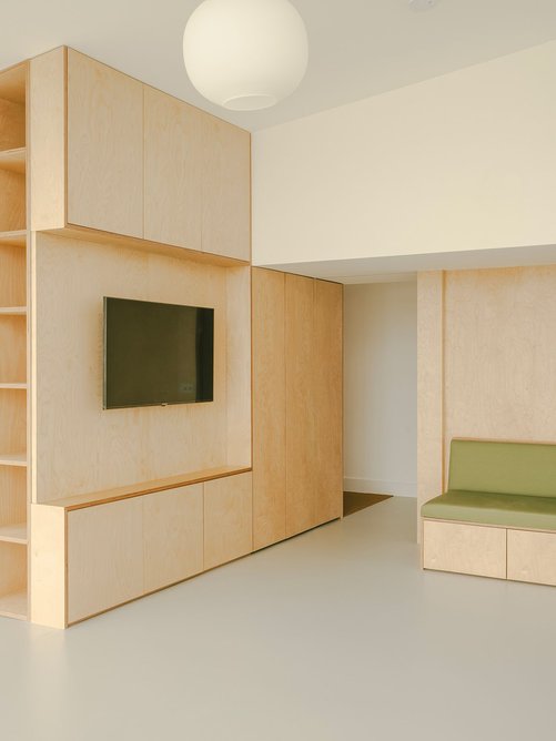 In the main living area, storage is built into partitions, walls and seating.