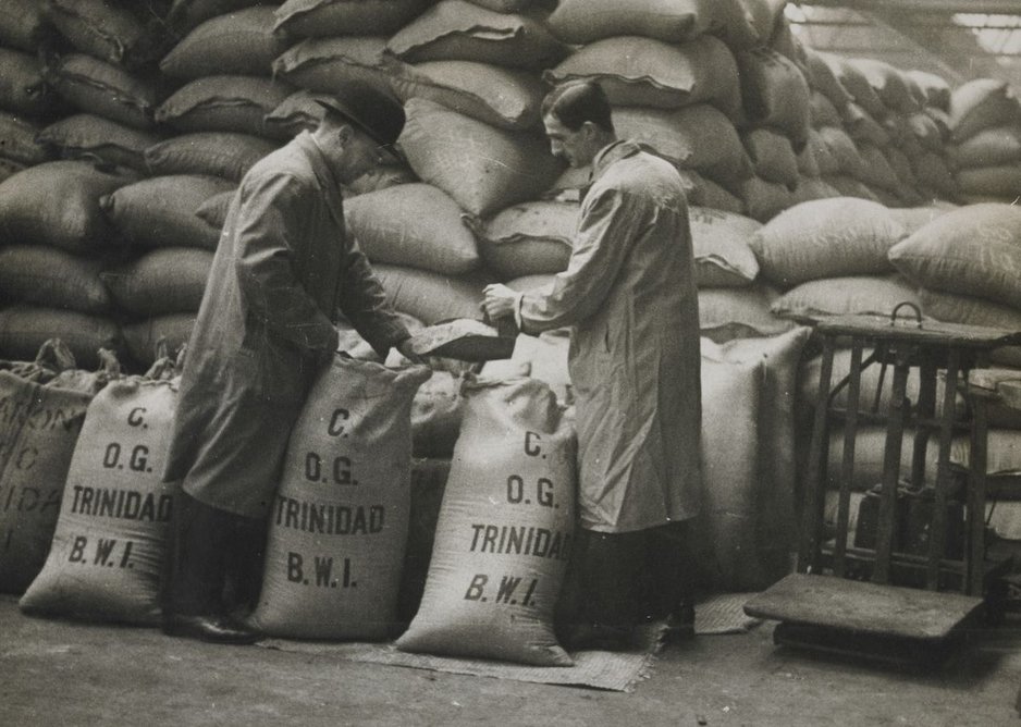 Retying sugar sacks after sampling, West India Docks.