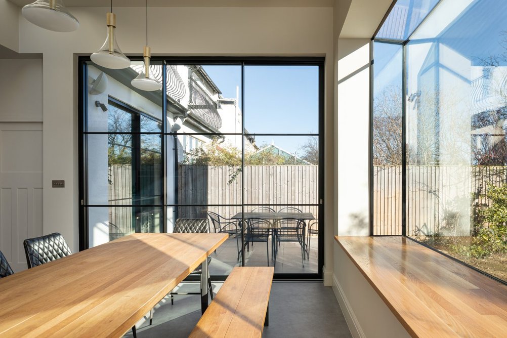 Maximising light with Maxlight industrial-style sliding doors and oriel bay window at a property in Haringey, north London.