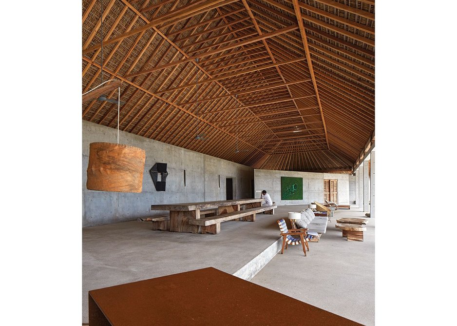 The pitched roof thatching over the communal room is left exposed, following the traditional format.