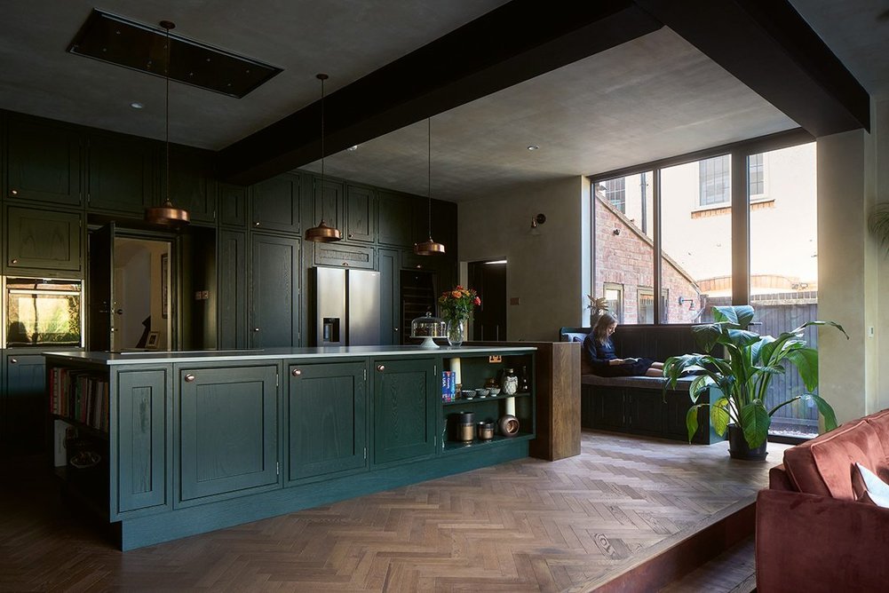 A single door in the wall by the kitchen storage leads back into the main body of the house.