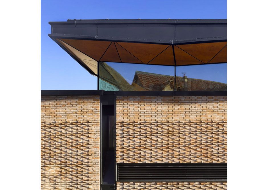 Façade detail showing the brickwork pattern and coordinated grilles.