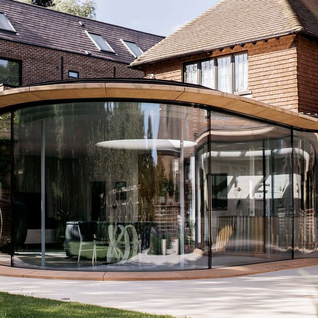 Liddicoat & Goldhill has added a large basement and sinuous garden room to a 1917 house