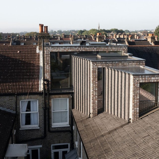 The distinct brick loft is expressed as a series of three stepped volumes hosting a bedroom, study and bathroom