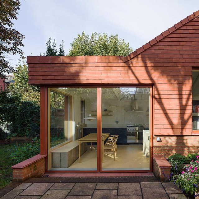 Brick and glass outbuildings inspire garden flat addition