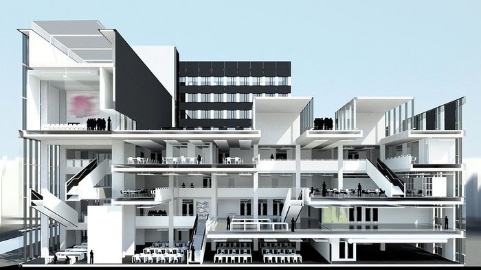 Living room’ to the left with cafe and dramatic stairs, topped by a grand lecture theatre/event space. ‘Factory’ to the right with design studio spaces and workshop. Lanterns at the top draw light into the deep space and sit as pavilions on the roof terrace. The reclad original sixties tower is visible behind.