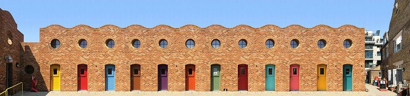 Holmes Road, designed by Peter Barber Architects is a development of micro houses for homeless people in Camden. Terraces face onto a communal garden.