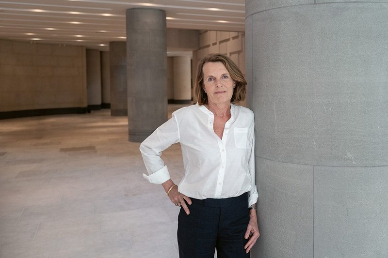 Annabelle Selldorf leans against a new column in the lobby, its incised Pietra Serena cladding reflecting the material’s use in the galleries above.