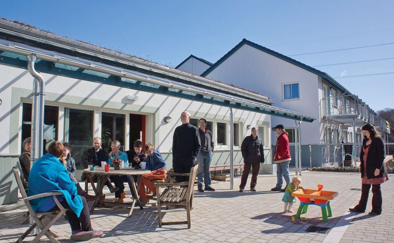 The Common House space, facing south over the river, acts as the physical and spiritual heart of the development.