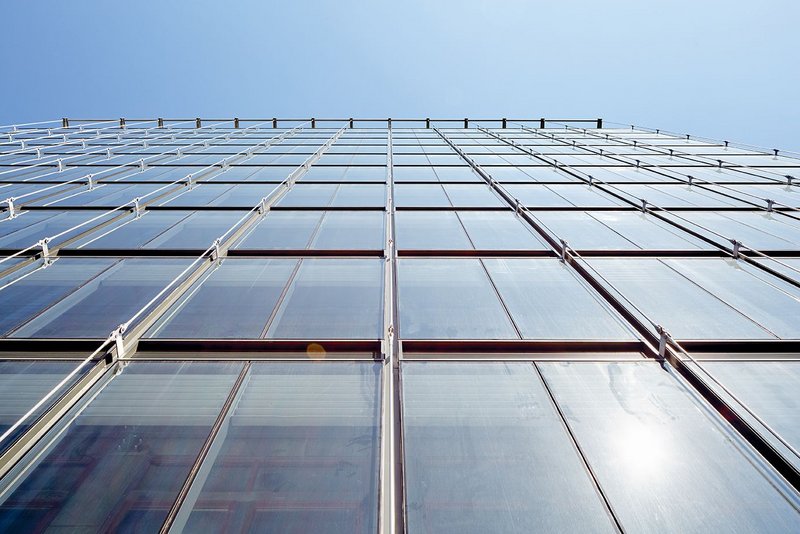 The new unitised facade is hung off cantilevered rooftop steelwork.