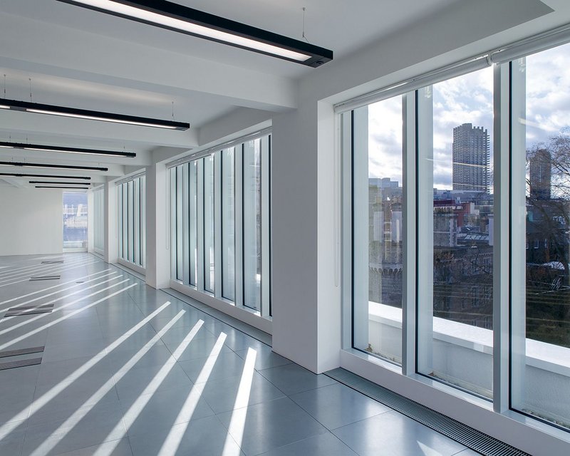 Interior of the new 4th floor. The curtain walling has external caps to create a strong vertical rhythm.