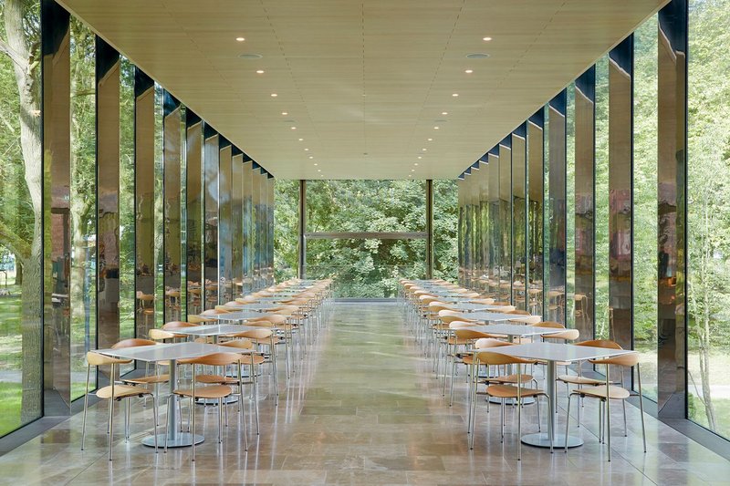 The café, which includes delicate, polished stainless steel structural mullions.