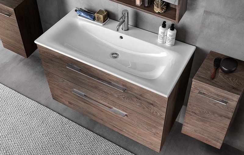 Warm wood and pleasing-to-the-touch ceramics: Geberit Selnova square washbasin with cabinetry in Dark Hickory.