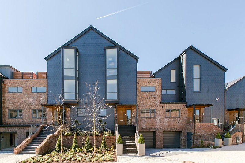 SSQ natural slate cladding at Chandlers Wharf, Lewes. The distinctive faintly rippled riven texture, deep blue-black colour and longitudinal grain make for distinctive buildings.