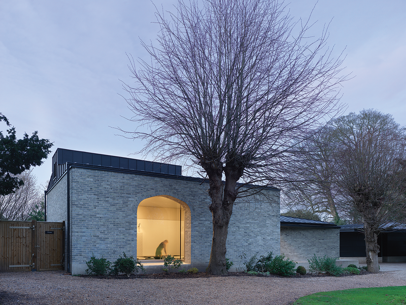 Pale bricks on a concrete plinth tie together existing brick wall and the rag stone of the castle.