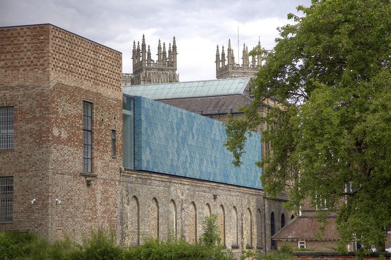 Facing the ruins of Museum Gardens with York Minster beyond, the ceramic wall is the outward sign of the reworking.