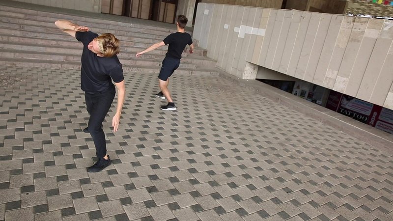 Dancers in the plaza under the cantilevered Khatob Opera House.