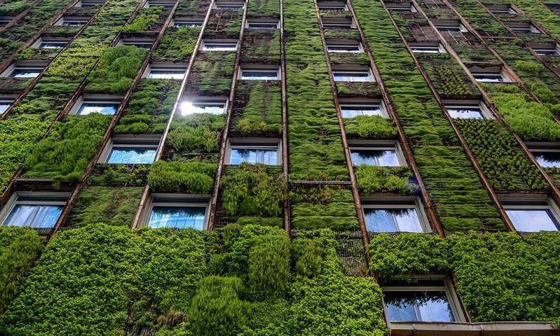 High-rise office building with a living facade that brings green infrastructure into the public realm.