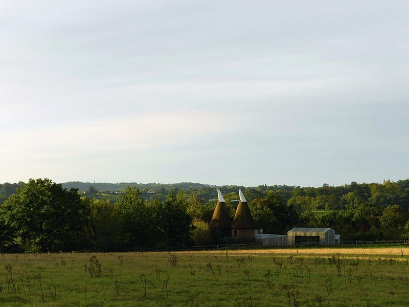 Fitting into the East Sussex landscape: a cluster of ‘agricultural’ buildings and two old oast houses.