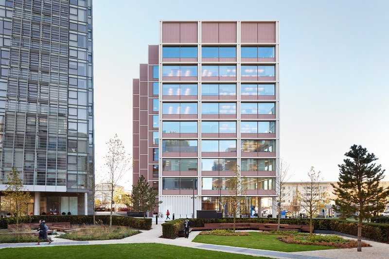 A palette of pinks, reds, and light concrete unifies interiors and exteriors.