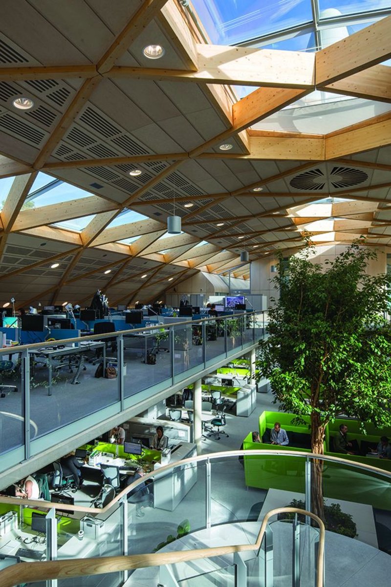 Phase change material and concrete help the thermal atmosphere almost invisibly while rooflights, nicely configured vents to the wind cowls and hefty indoor trees bring another sort of life to the office.