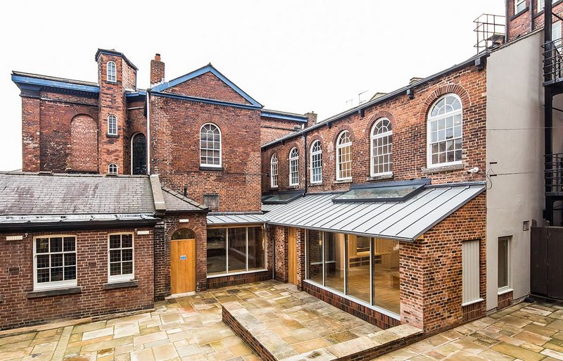 The Hollis Building project by Chiles Evans + Care Architects unites two back-to-back chapels. A new extension floods the spaces with daylight.