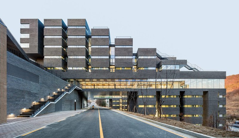 At Daejeon University’s dormitory and student centre (2018) the megastructure fully uses a 26m sectional drop on a steeply sloping hillside.