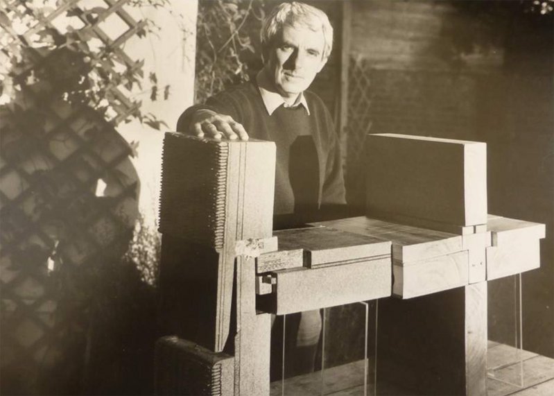 Sam Webb in the 1980s, with a wooden model used to explain building joints to tenants.
