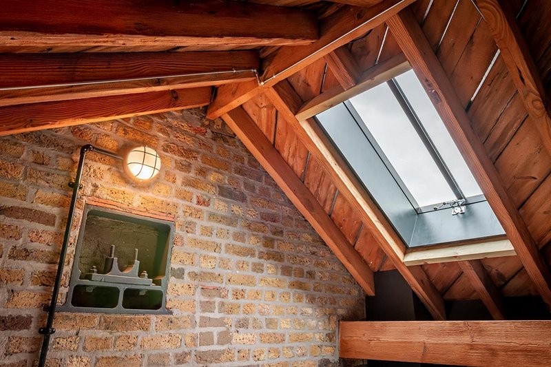 The Rooflight Company's Conservation design at Butler's & Colonial Wharf. It features slim clean lines, a low-profile to match the roofline and linking bars.