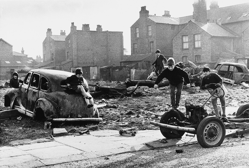 Manchester, 1968 [image of children in abandoned cars] by Shirley Baker.