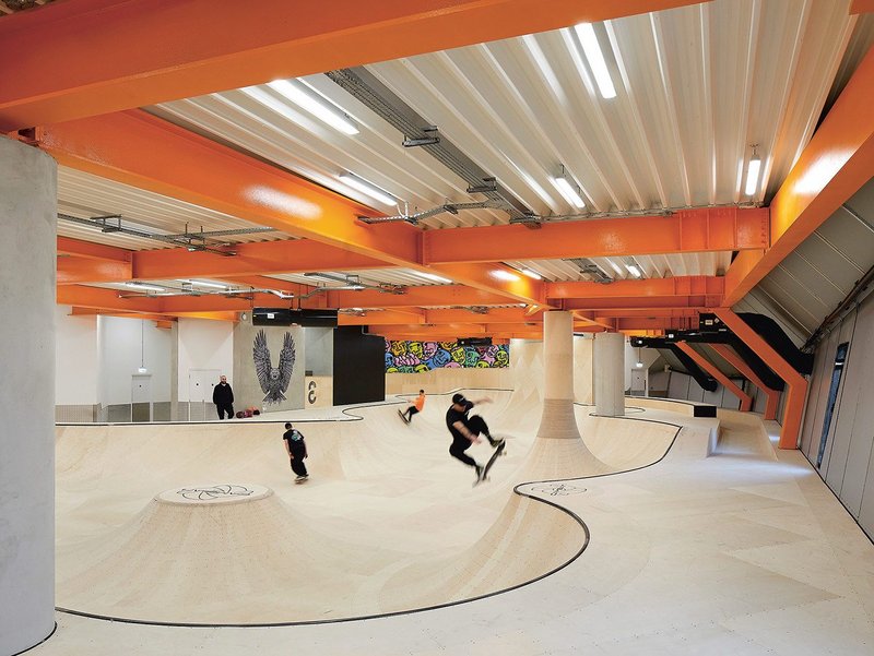 The Modern Bowl on the concrete first floor, the shapes of which appear to hang mid-air, punctuating the curtain walling and ceiling of the reception floor.