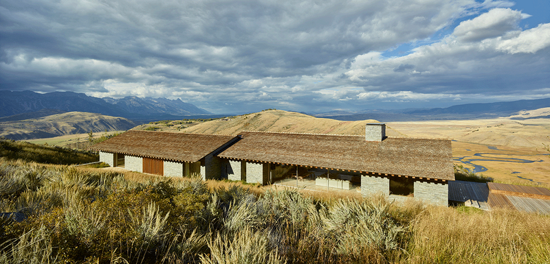 House at Jackson Hole in Wyoming (2018) for a German and New Zealand couple that had been living and working in California. The house uses local stone on the walls and timber shingles on the roof, the large side openings are mirrored on the opposite elevation so views carry through the building