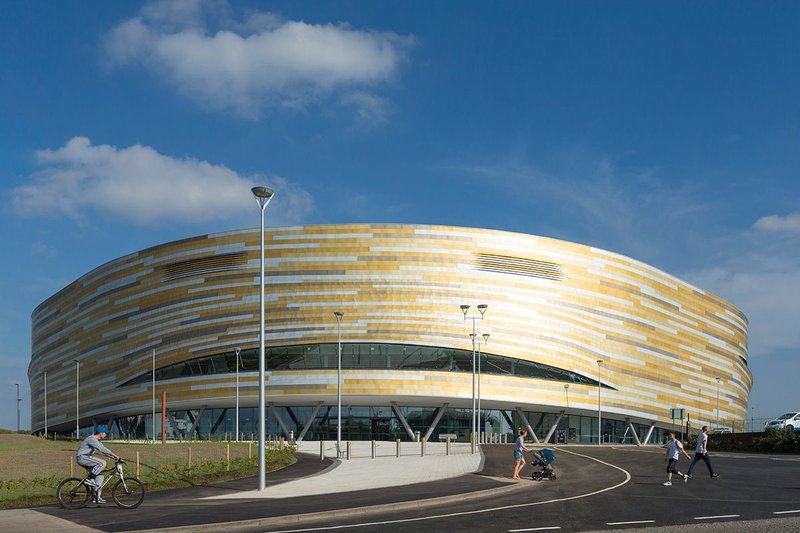 The giant steamer basket splits above the entrance, glazing marking the track level