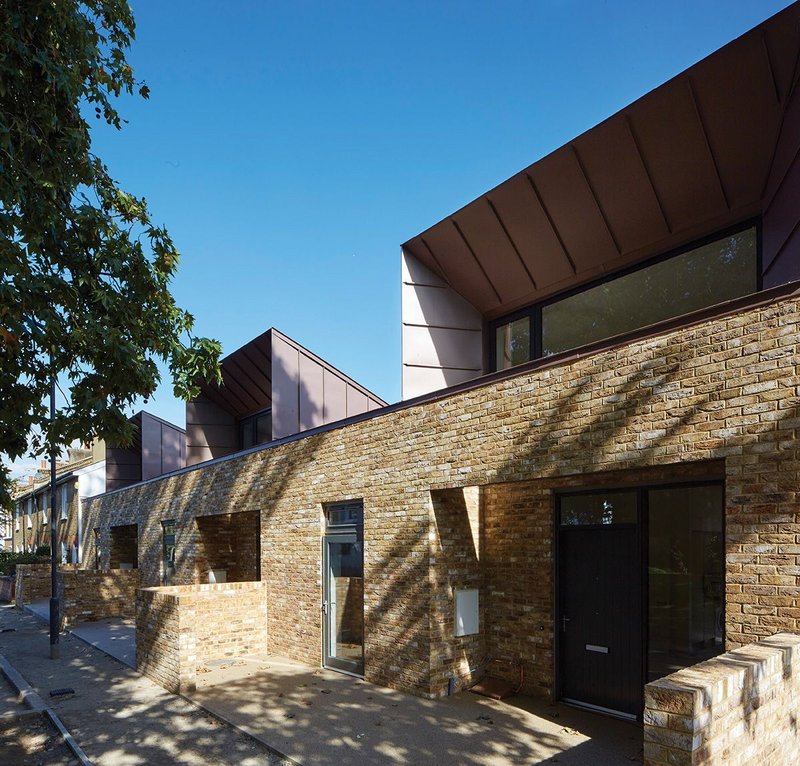 Mottled brick sitting happily alongside conservation area cottages in Walnut Tree Road.