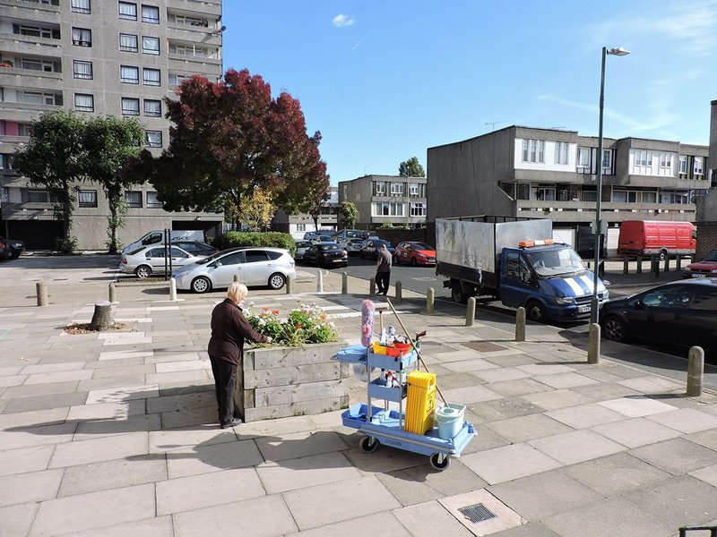 A Peabody member of staff tends flower beds at Thamesmead.