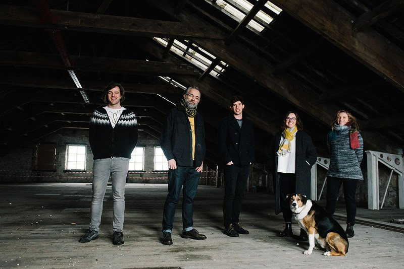 Gagarin Studio in their latest project, Old Town Mills in Hebden Bridge. Left to right: Andrew Dent, Stephen Gittner, Patrick Cook, Gayle Appleyard, Chiara Ulivelli. And office dog  Alan ’Shep’ Shepard, like the practice named after an early astronaut. Credit Sarah Mason