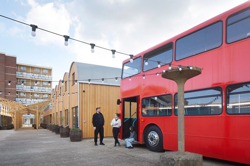 Two-storey units run as far as the play street at the north of the site. A double decker bus is a makeshift social space.