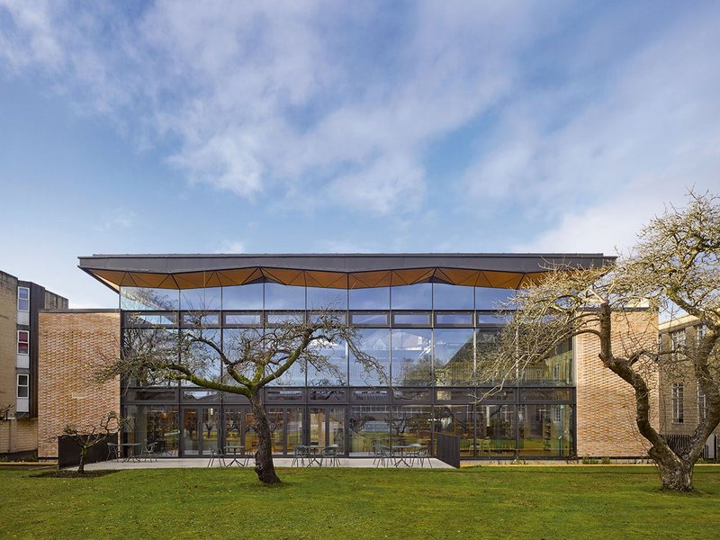 The east elevation overlooks the orchard but a brick skin wraps around and behind it.