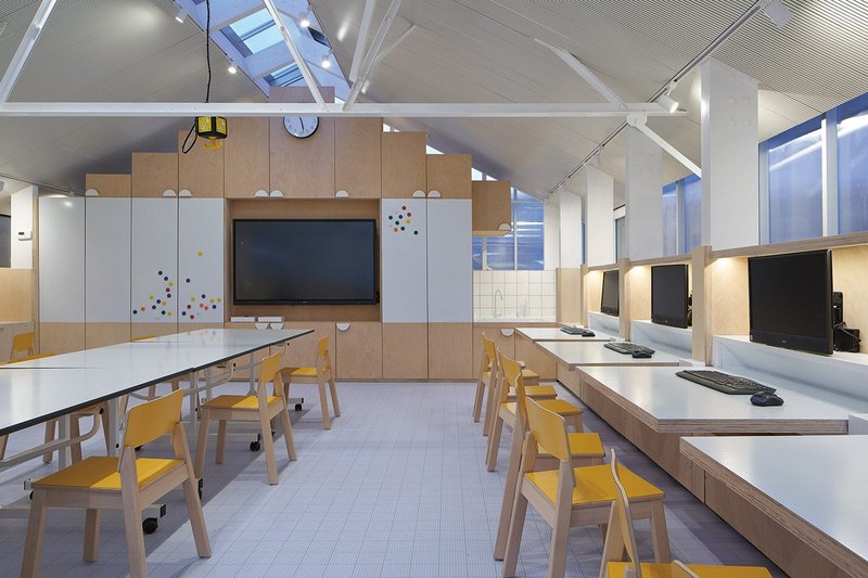 With side desks hinged, the STEM Lab is a versatile space, here set up with trestle tables for formal teaching.