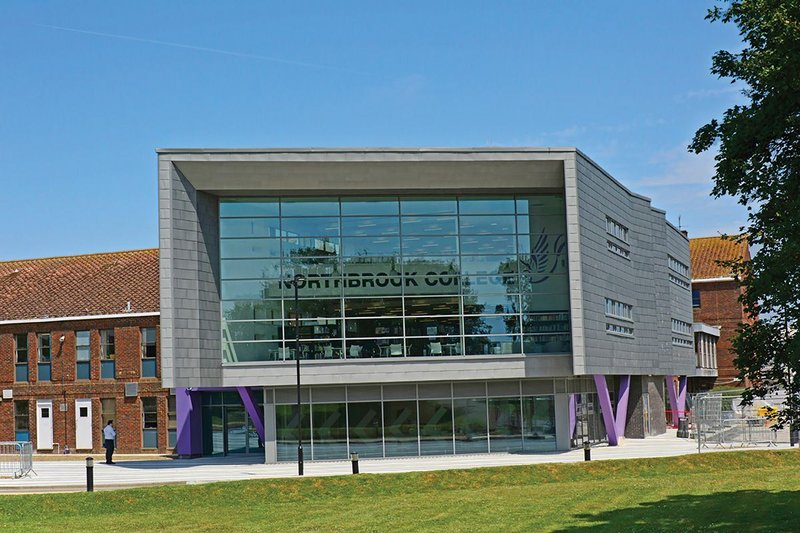 The front elevation of Northbrook College’s new learning centre framed in its zinc shingle skin.